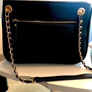 INC black shoulder bag. New w/tag. Snap top closure. Zippered sides that expand
